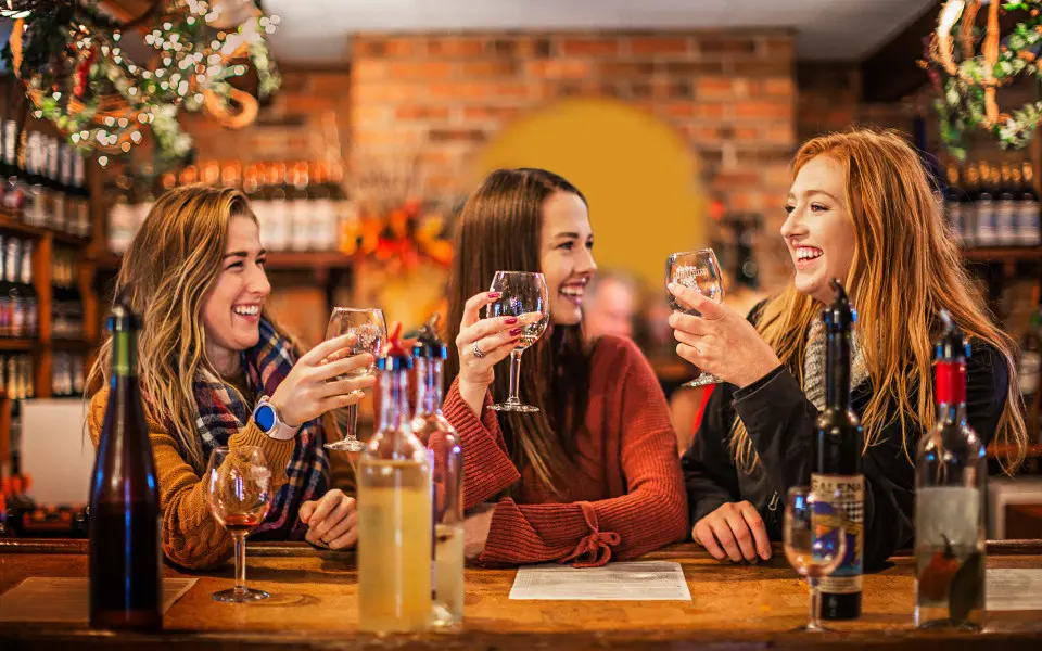 Three woman drinking wine together